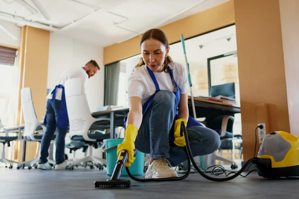 A professional cleaning service person using a vacuum cleaner school