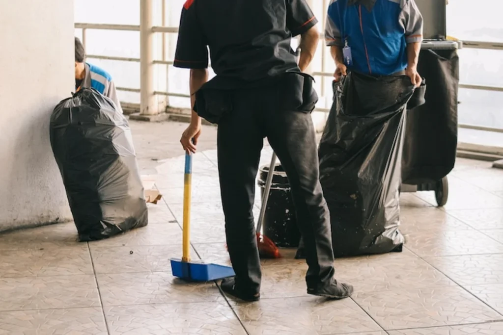 Janitor men cleaning the building area with cleaning equipment and tools

